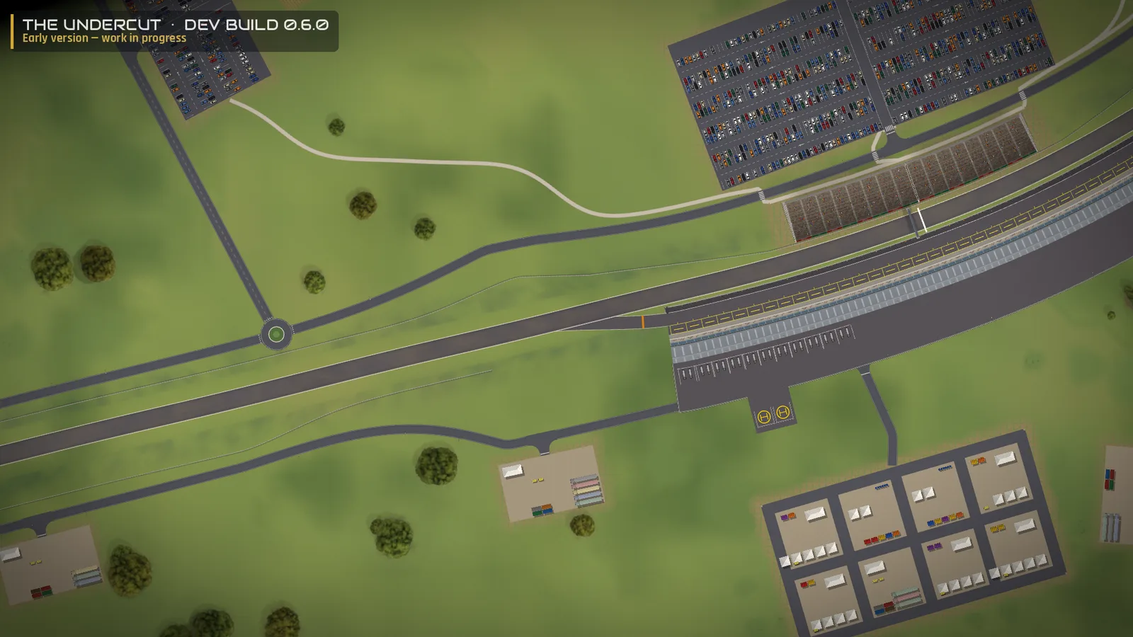 The Undercut, Entwicklungsversion 0.6.0 – die Start-Ziel-Gerade: Haupttribüne und ein voller Parkplatz, Boxengebäude und Boxengasse, Hubschrauberlandeplatz und das Fahrerlager mit den Teambereichen